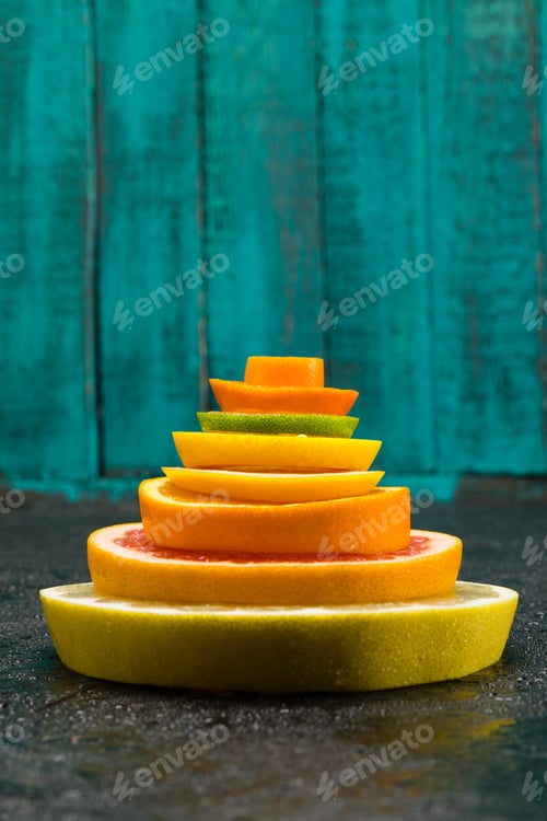 Preview: close up view of different fresh citrus fruits slices on blue