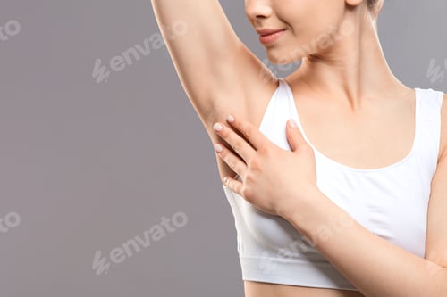Preview: Unrecognizable woman touching her armpit, copy space