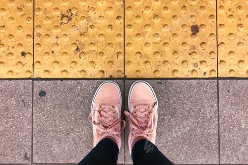 Preview: Pink Sneakers on Textured Urban Pavement