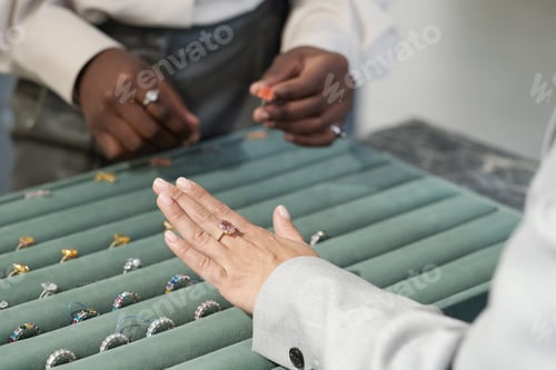 Preview: Hand of female customer trying on ring with gemstone