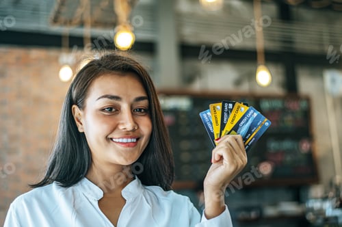 Preview: Young women enjoy shopping with credit cards.