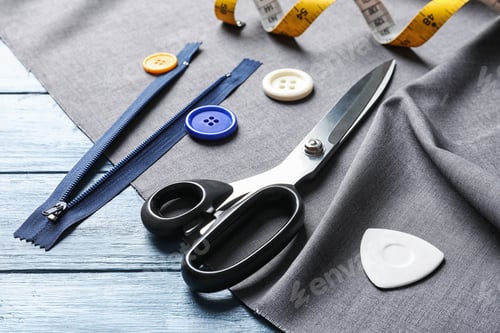 Preview: Set of tailoring accessories and fabric on wooden background