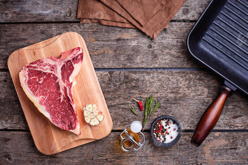 Preview: Raw T-bone steak and iron grill pan