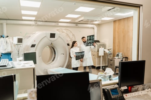 Preview: CT doctors discussing brain x-rays of patient and consulting computed tomography results