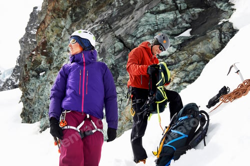 Preview: Mountaineers preparing equipment on snow-covered mountain, Saas Fee, Switzerland