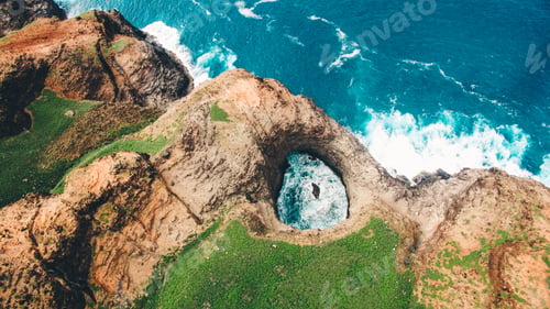 Preview: Overhead ariel shot of beautiful OpenCeiling Sea Cave on the Na Pali Coast of Kaua’i with greenery