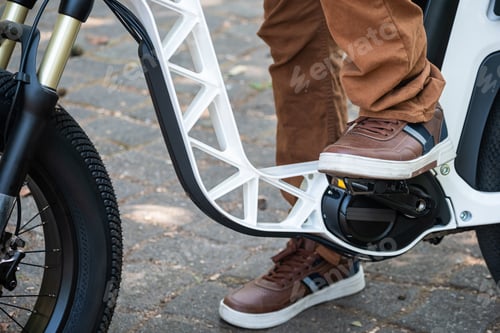 Preview: Man foot on pedal of electric bicycle