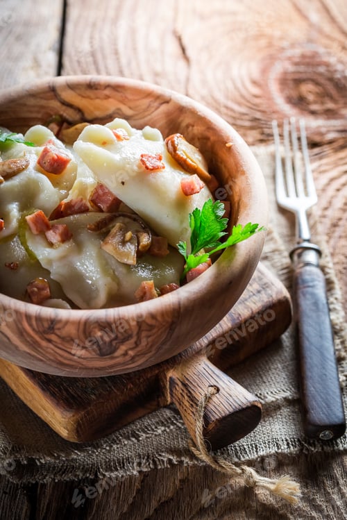 Preview: Tasty dumplings with mushrroms and onion on old wooden table