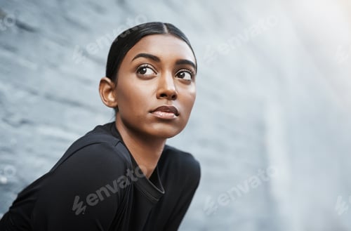 Preview: Shot of a fit young woman getting ready to workout outdoors