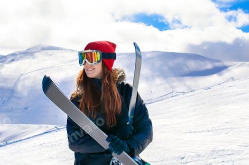 Preview: Happy girl woman with skies in snowy mountains at winter,extreme sport