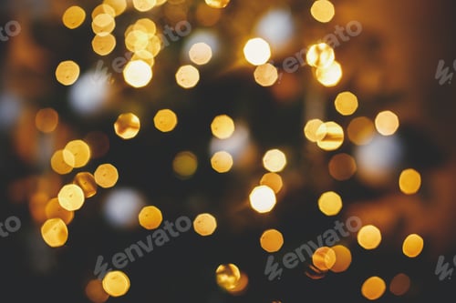 Preview: Golden Christmas lights bokeh.Christmas abstract background, defocused illumination. Merry Christmas