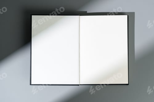 Preview: Blank open notepad on gray background studio shot