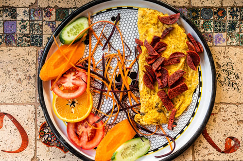 Preview: Omelet with sausage and vegetables in white plate