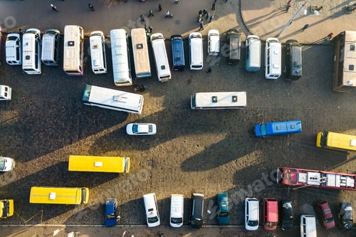 Preview: Aerial view of many cars and buses moving on a busy city street.