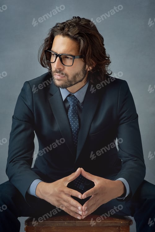 Preview: Studio shot of a well-dressed businessman against a grey background