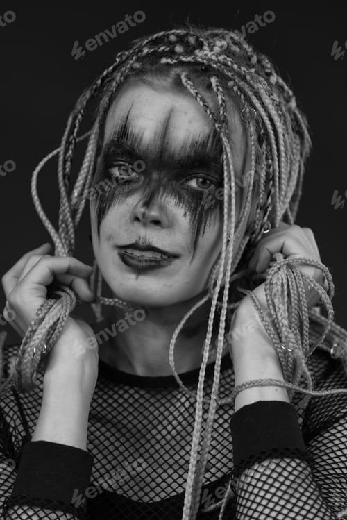 Preview: Black and white portrait of woman with dreadlocks hairstyle and horror stage make-up painted on face