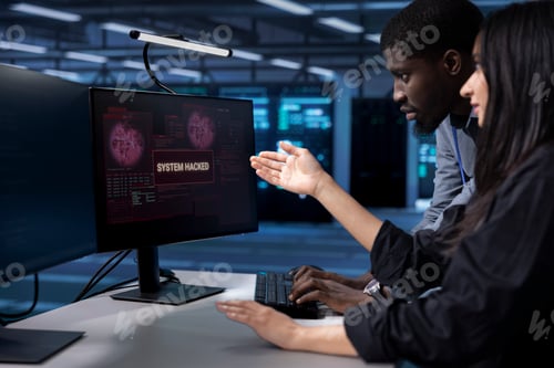 Preview: Programmers doing teamwork in server hub trying to protect hardware from hacker