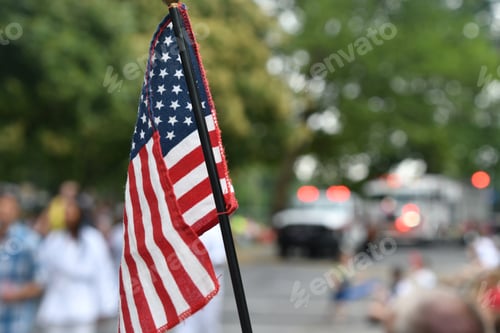 Preview: Watching the Independence Day Parade on the 4th of July while waving an American flag.