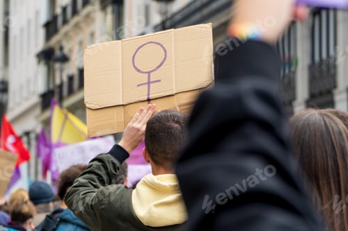 Preview: Young adult men with feminist message placard