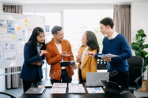 Preview: Happy businesspeople while collaborating on a new project in office. Group of diverse businesspeople