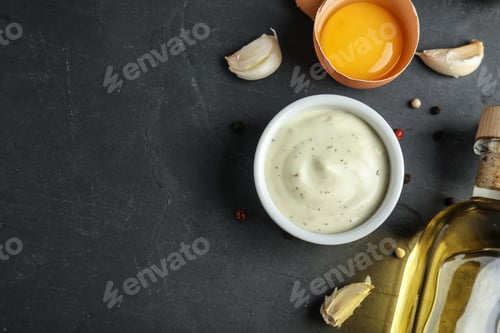 Preview: Flat lay composition with garlic sauce on dark background. Space for text