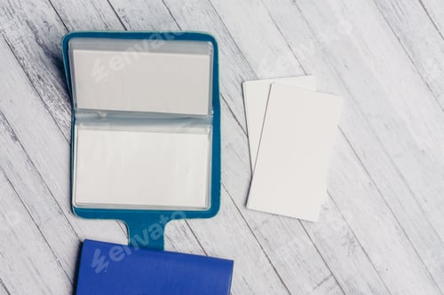 Preview: blue business card holder with letterheads on a wooden table top view