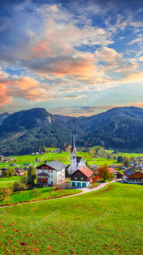 Preview: Alpine green fields and traditional wooden houses view of the Go