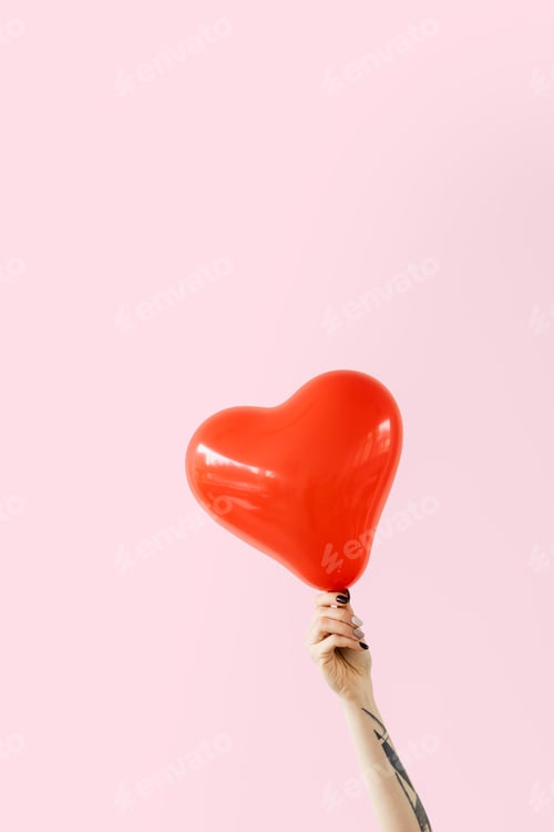 Preview: Tattooed arm holding a red heart shape balloon mockup