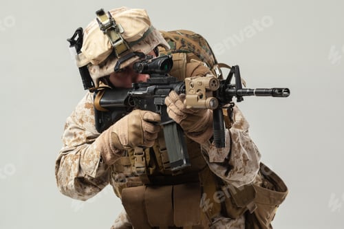 Preview: Soldier in uniform holds weapon in preparation for training or combat scenario