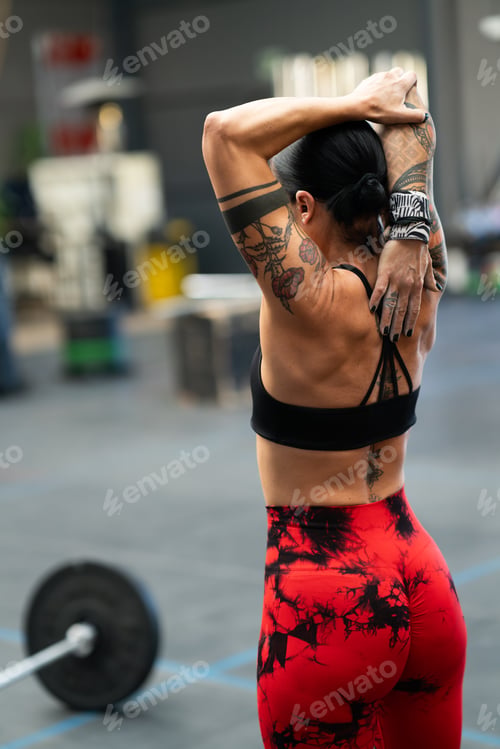 Preview: Athlete stretching after working out in a gym