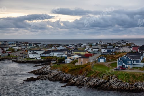 Preview: Homes in a little town on the rocky Atlantic Ocean Coast during a cloudy sunset
