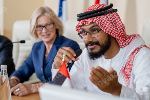 Preview: Bearded delegate in turban and eyeglasses making report