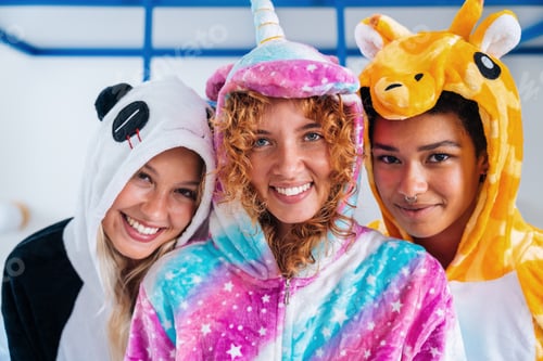 Preview: Multiethnic group of young female friends having pajamas party at home