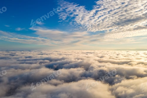 Preview: Aerial view from above of white puffy clouds in bright sunny day