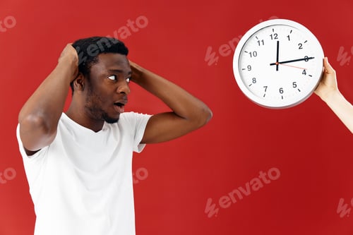 Preview: man african appearance in white t-shirt clock studio