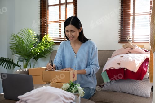 Preview: Female startup small business owner working with notebook computer at office. Online selling. E-comm
