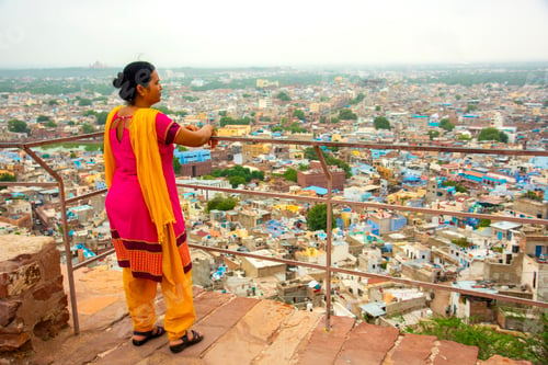 Preview: Portrait of Indian woman against view of Jodhpur the blue city in Rajasthan India