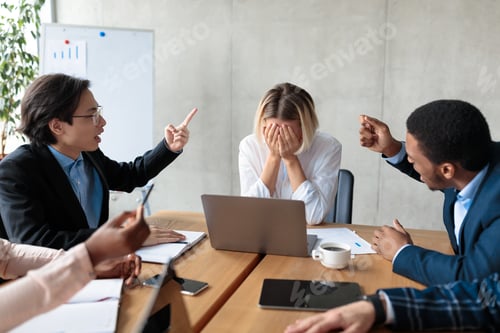 Preview: Colleagues Shouting At Unhappy Victimized Businesswoman Sitting In Modern Office