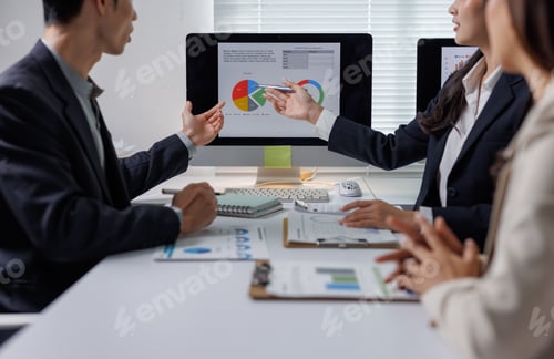 Preview: Business people discussing data analysis during corporate meeting