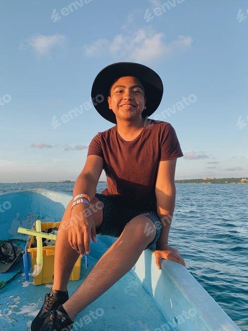 Preview: boy in a boat in the middle of the sea
