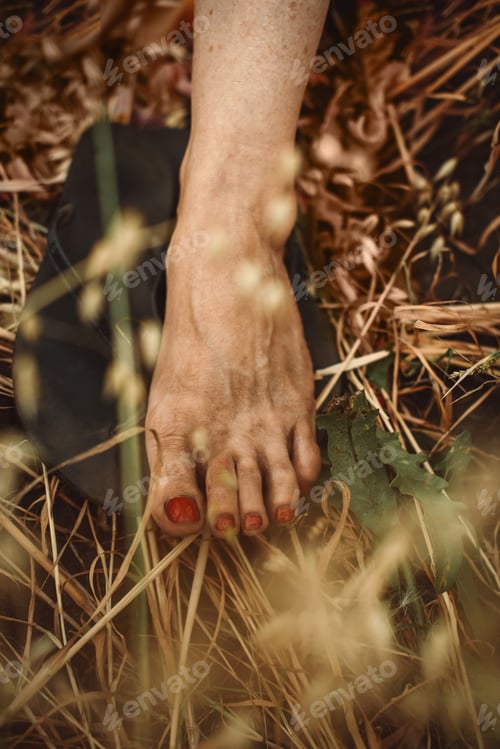 Preview: Dusty messy female foot on black ground in field