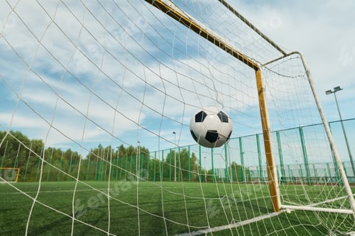 Preview: Soccer Ball Hitting Net Scoring Goal on Outdoor Field during Sunny Day