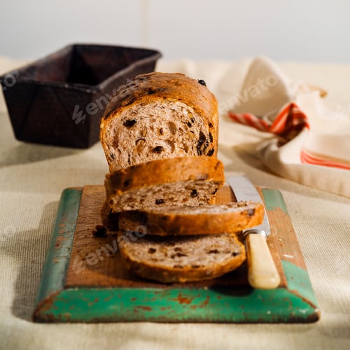 Preview: Sliced loaf of raisin bread on cutting board