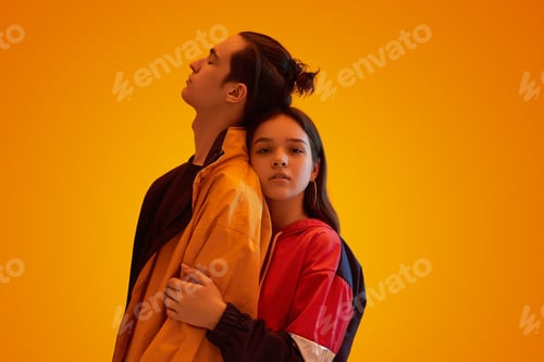Preview: Loving couple of teenagers hugging in studio