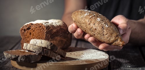 Preview: baker holding fresh bread in hands