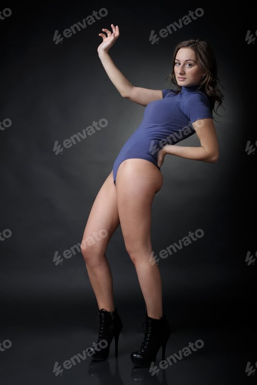 Preview: Woman In Bodysuit On Dark Studio Background