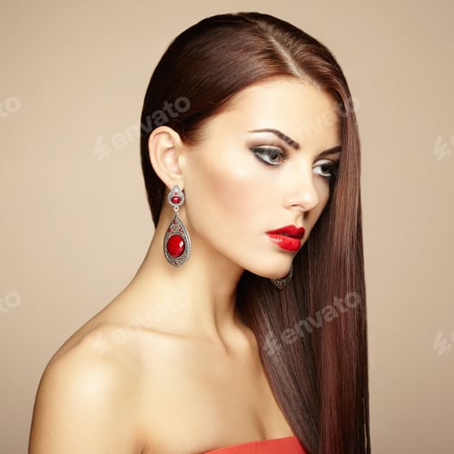 Preview: Portrait of beautiful brunette woman with earring. Perfect makeu