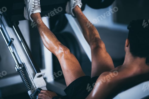 Preview: young fitness person execute exercise with exercise-machine in gym