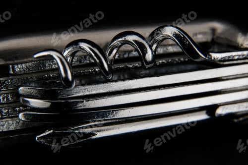 Preview: Grayscale shot of a small pocket knife under the lights against a black background