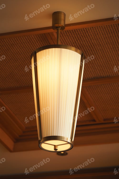 Preview: Elegant pendant light illuminating a warm interior space